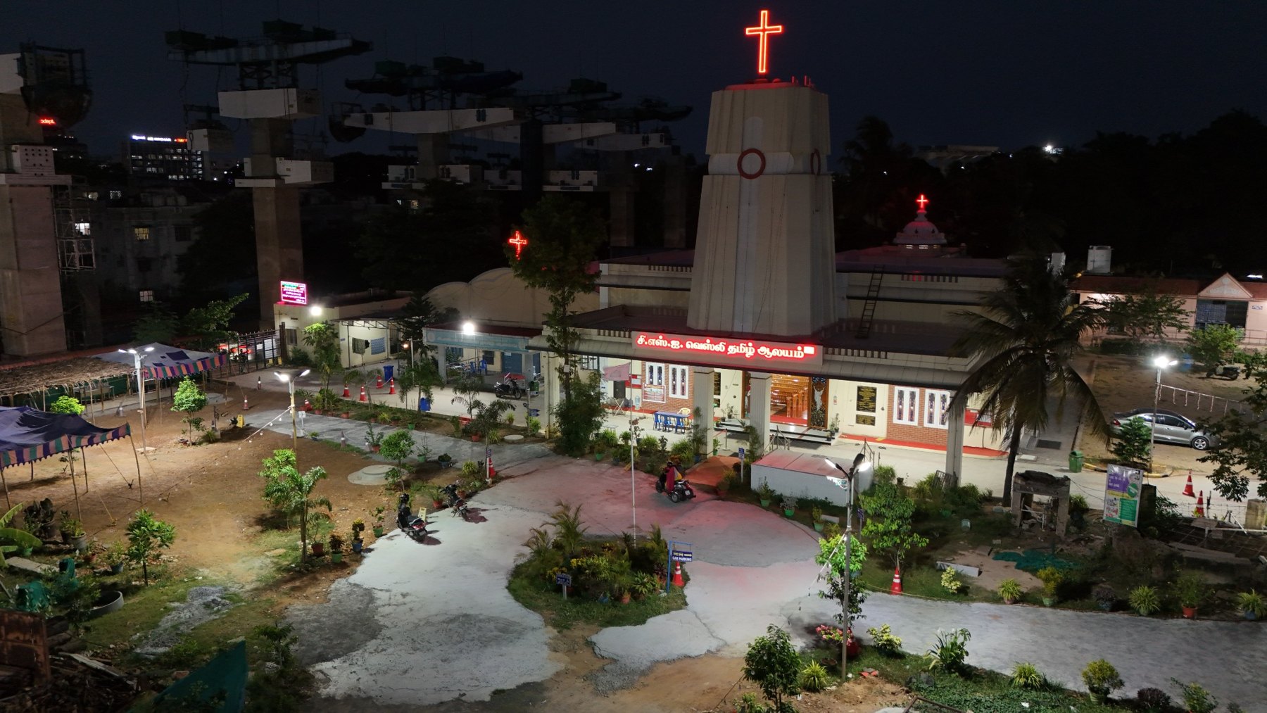Evening aerial view of the church with its illuminated crosses
